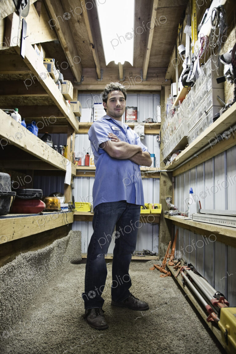Caucasian man employee standing in the parts department of a landscape company.
