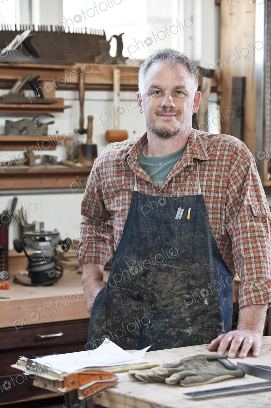 Caucasian man factory worker at a work station in a woodworking factory.