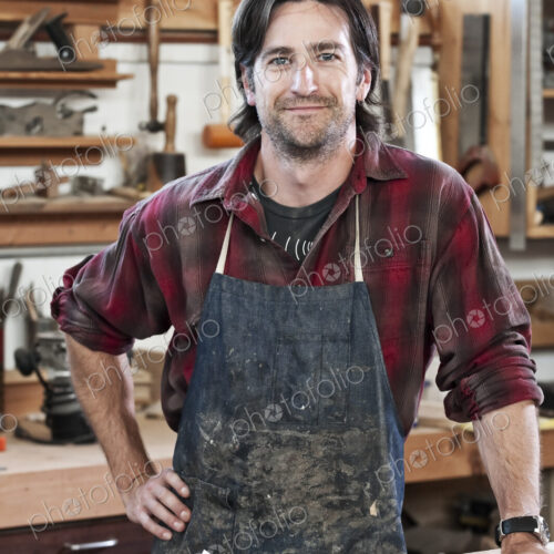 Caucasian man factory worker at a work station in a woodworking factory.