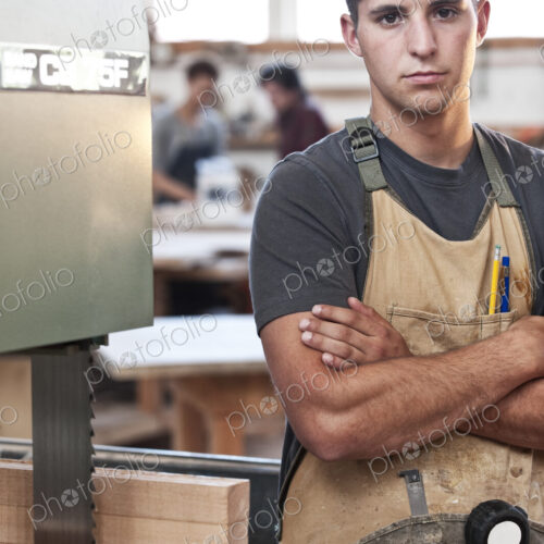 Caucasian man factory worker at a work station in a woodworking factory.