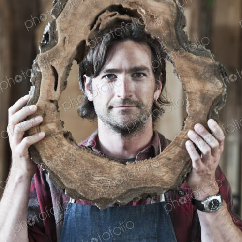 Caucasian man factory worker holding a cut piece from a section of a reclaimed…