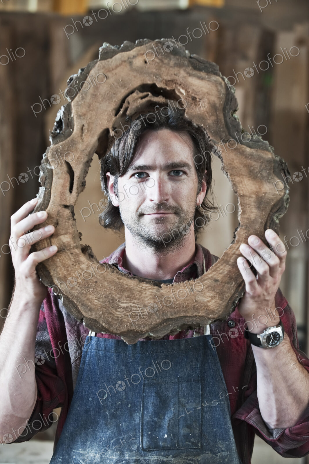 Caucasian man factory worker holding a cut piece from a section of a reclaimed…
