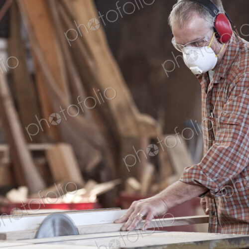Caucasian man factory worker wearing hearing protection and a nose dust mask while… Caucasian man factory worker wearing hearing protection and a nose dust mask while…