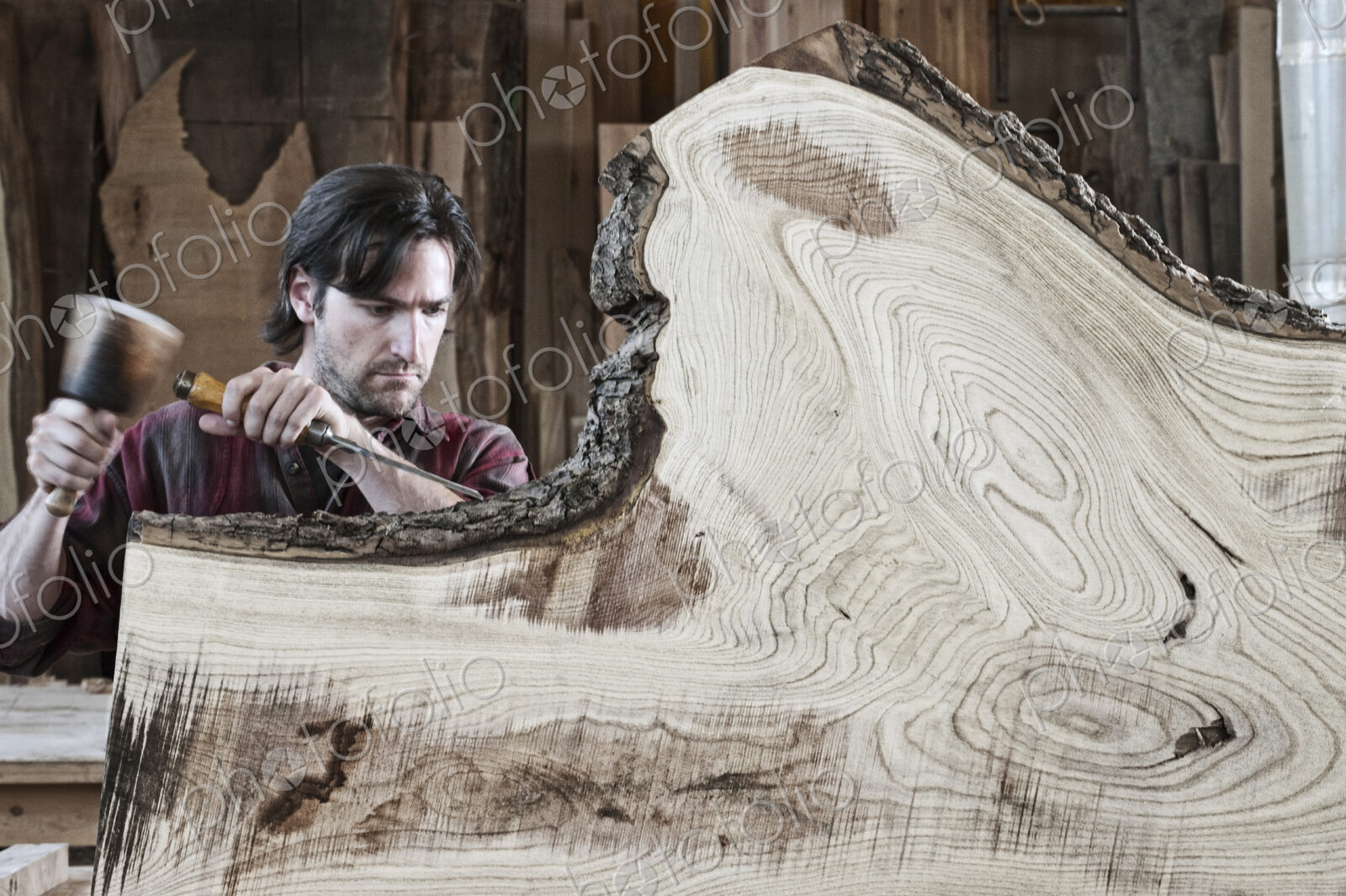 Caucasian man factory worker working on a cut piece from a section of a reclaimed…