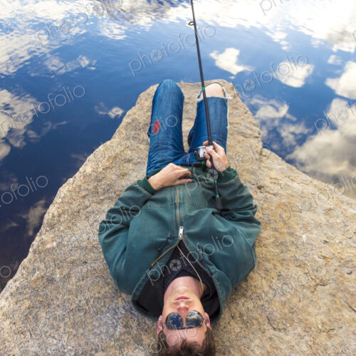Caucasian man fishing in remote lake