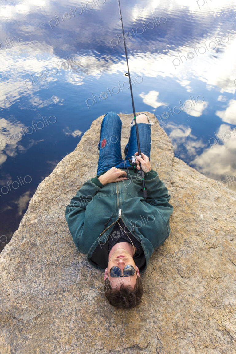 Caucasian man fishing in remote lake