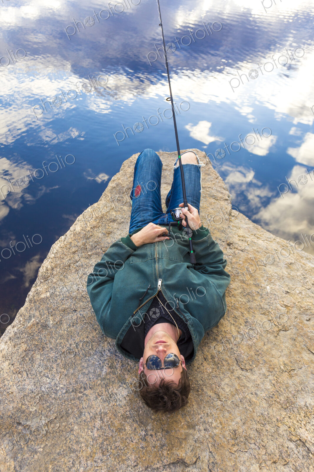 Caucasian man fishing in remote lake