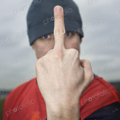 Caucasian man giving the viewer the finger as an obscene gesture. Caucasian man giving the viewer the finger as an obscene gesture.