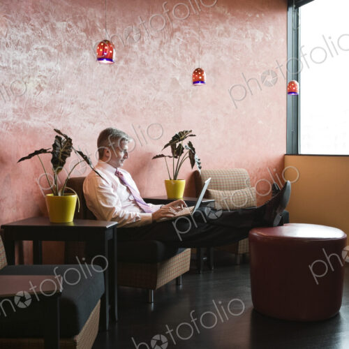 Caucasian man in an hip office lobby area Caucasian man in an hip office lobby area