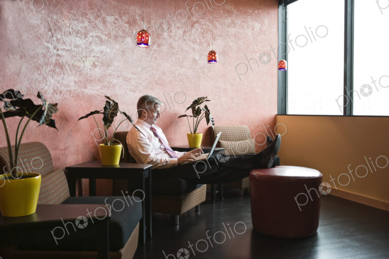 Caucasian man in an hip office lobby area