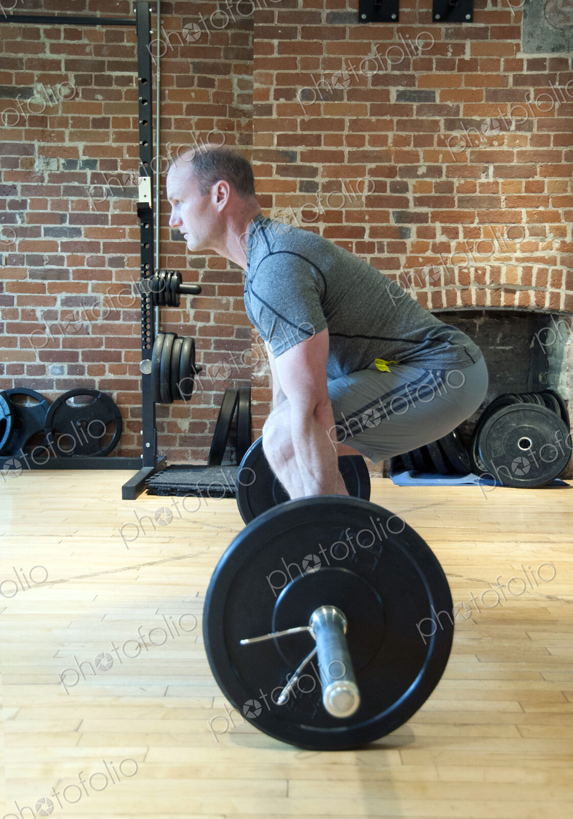 Caucasian man lifting weights in gymnasium