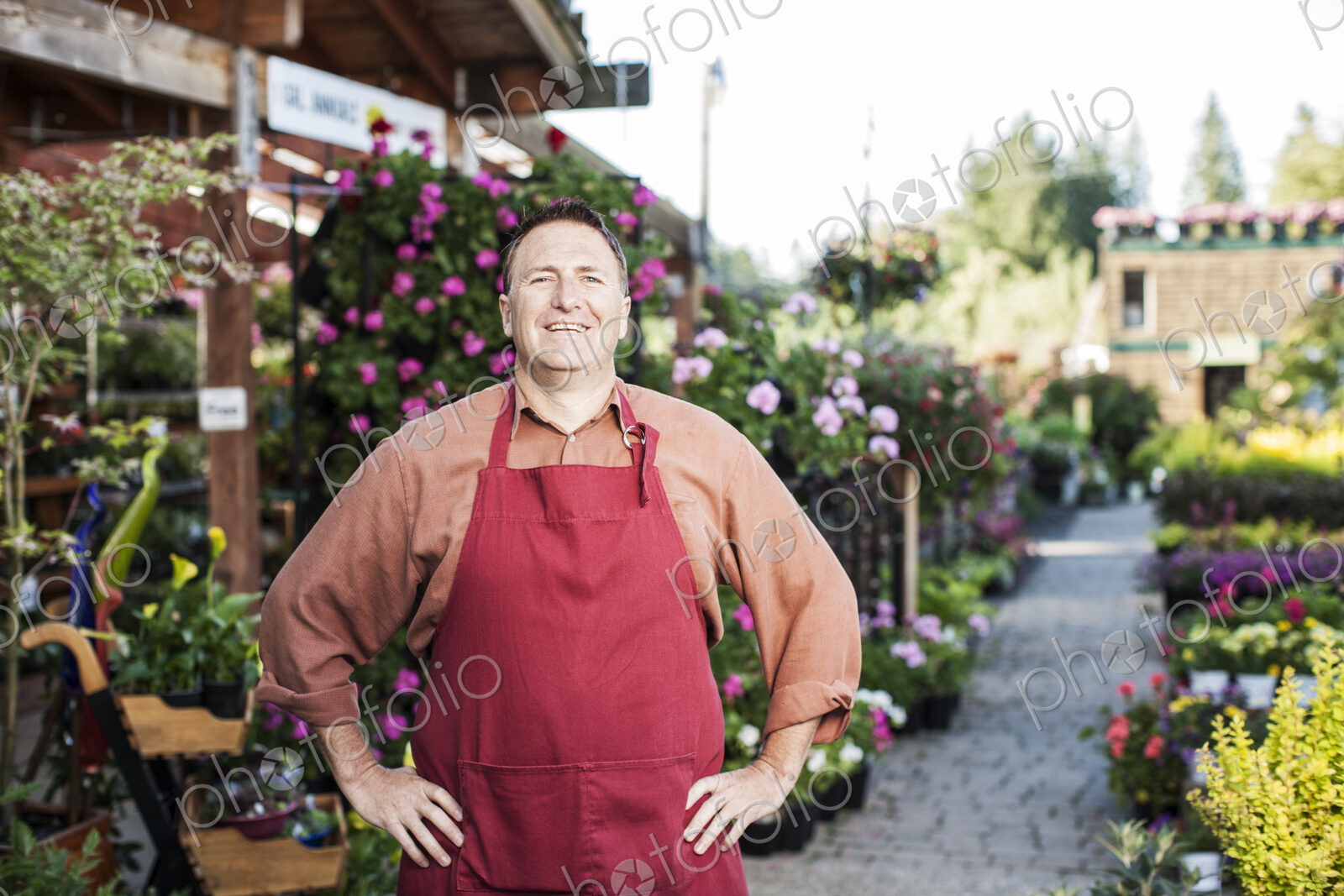 Caucasian man nursery owner standing with plants for sale at the nursery.