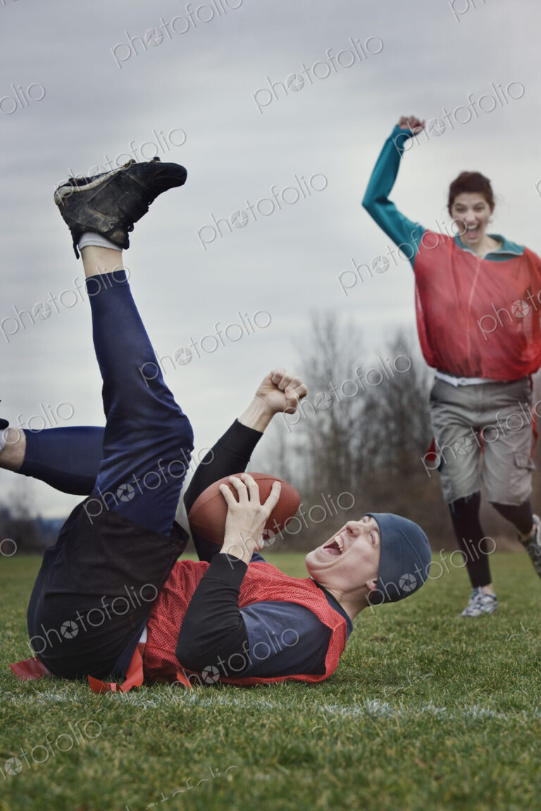 Caucasian man on the ground, punching the air, celebrating scoring points with the…