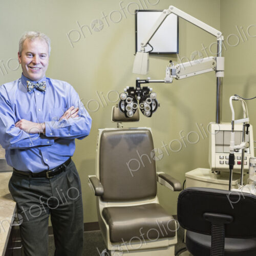 Caucasian man ophthalmologist in his examination room. Caucasian man ophthalmologist in his examination room.