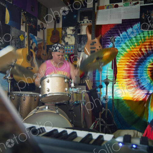 Caucasian man playing drums in music studio