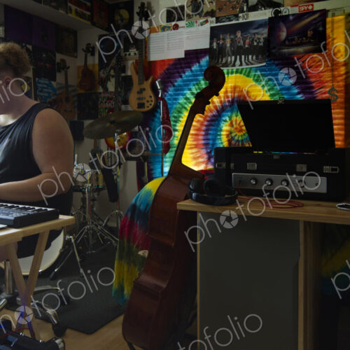Caucasian man playing keyboard in music studio