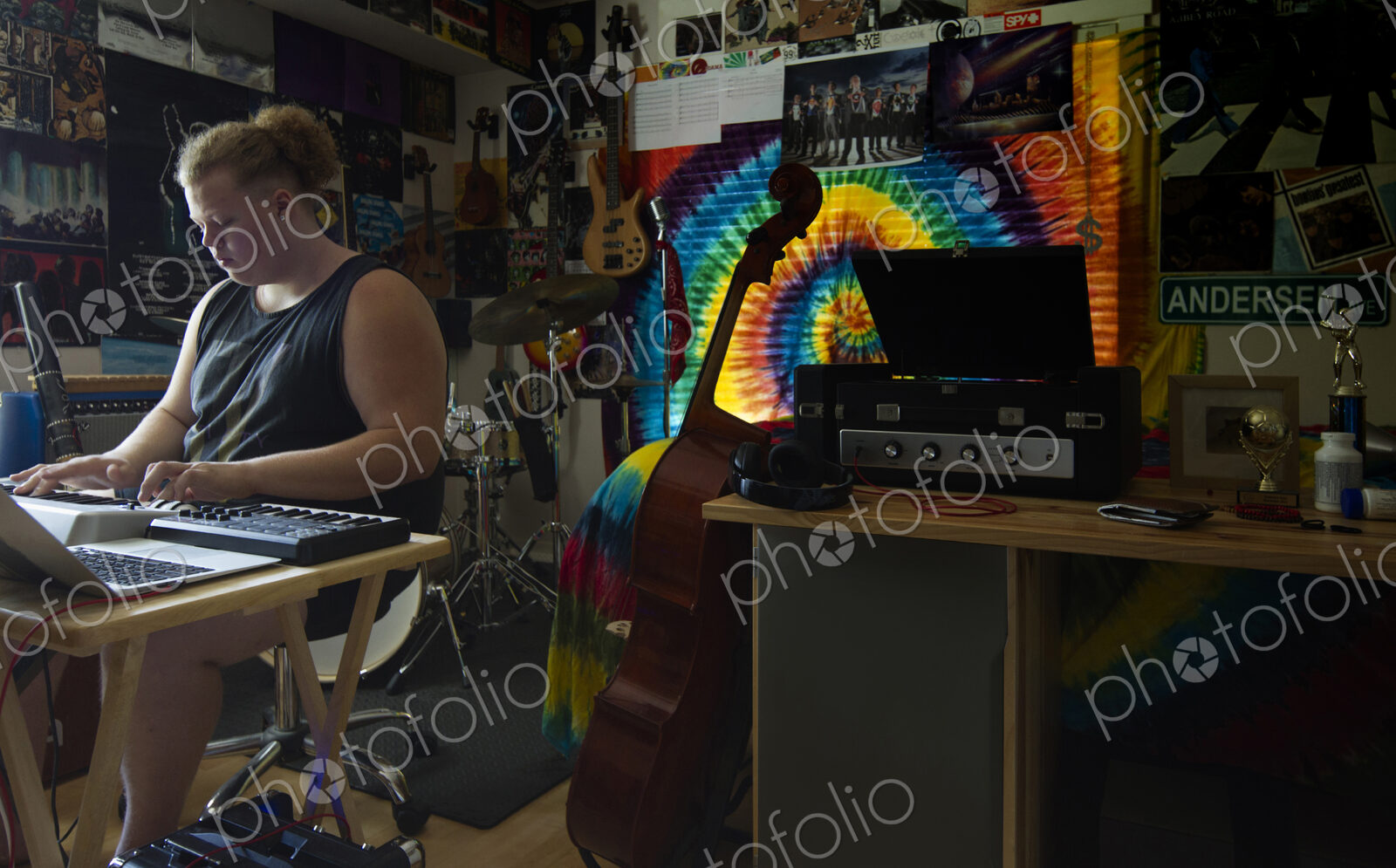 Caucasian man playing keyboard in music studio