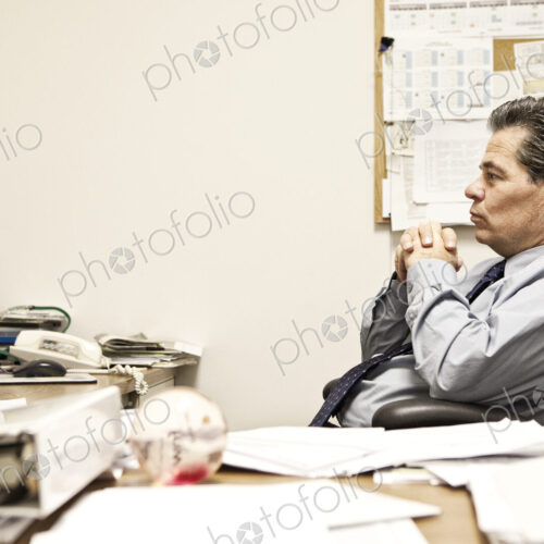 Caucasian man problem solving at his office desk.