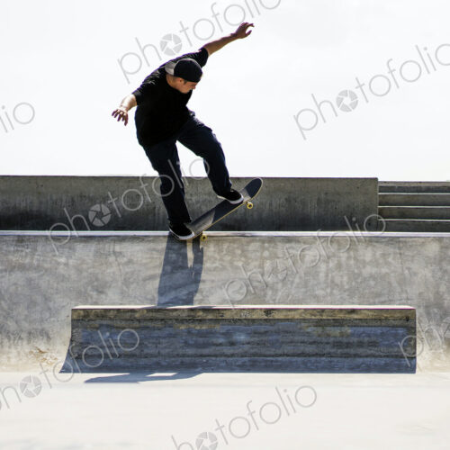 Caucasian man riding skateboard in skate park Caucasian man riding skateboard in skate park