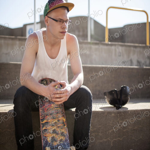 Caucasian man sitting at skate park
