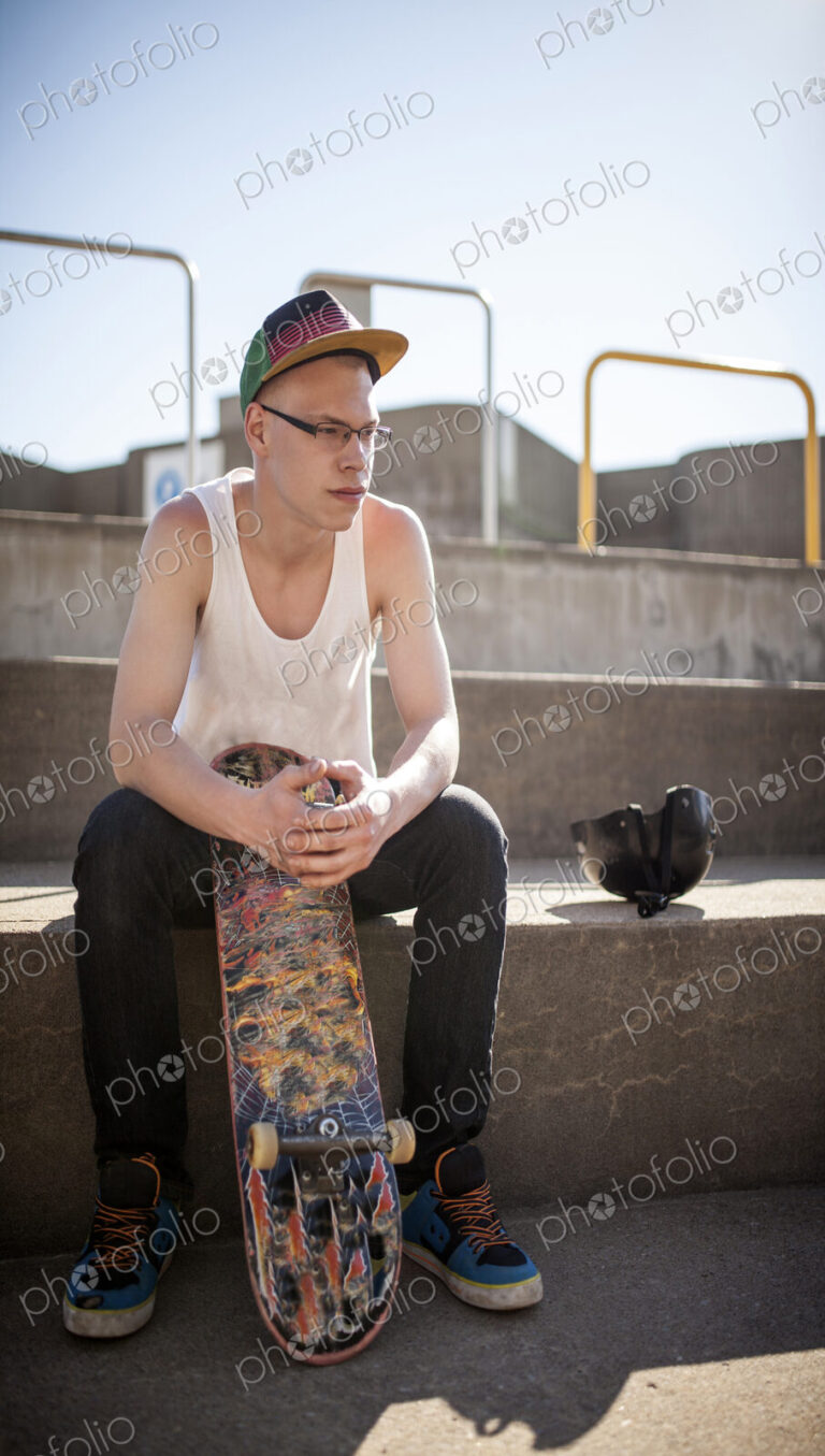 Caucasian man sitting at skate park