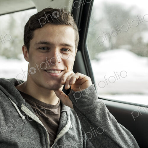 Caucasian man sitting in back seat of car