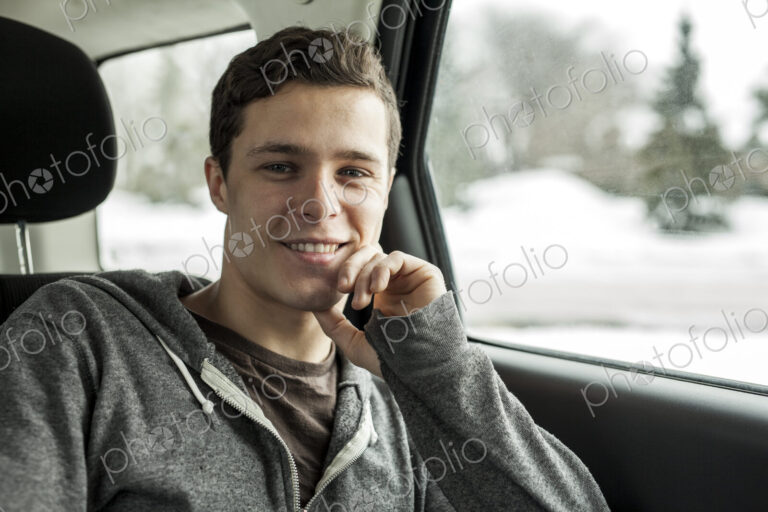 Caucasian man sitting in back seat of car