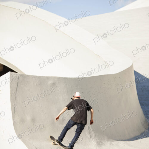 Caucasian man skating at skate park Caucasian man skating at skate park