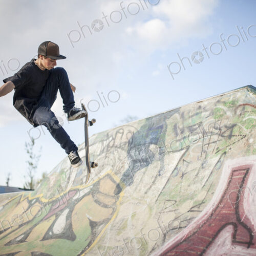 Caucasian man skating at skate park Caucasian man skating at skate park