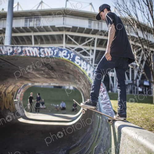 Caucasian man skating on half pipe at skate park