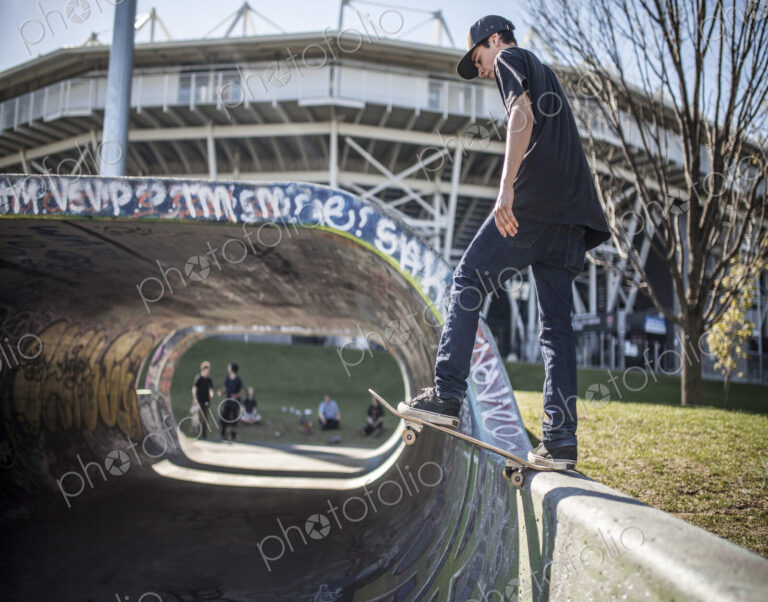 Caucasian man skating on half pipe at skate park
