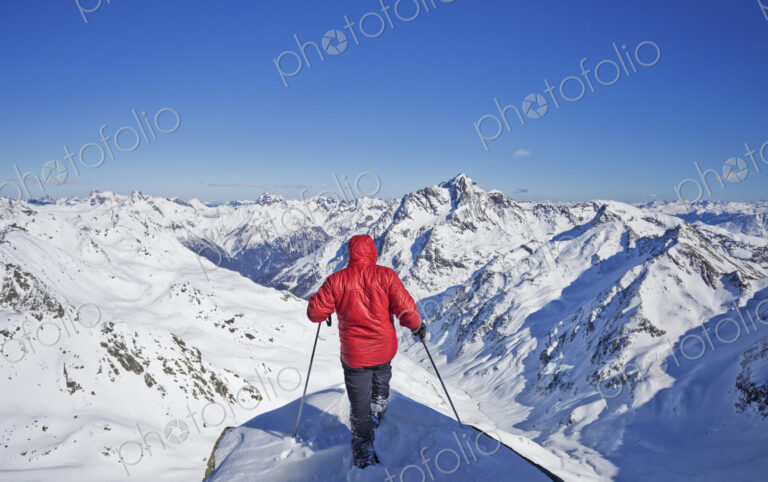 Caucasian man skiing on snowy mountaintop