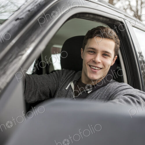 Caucasian man smiling in car window