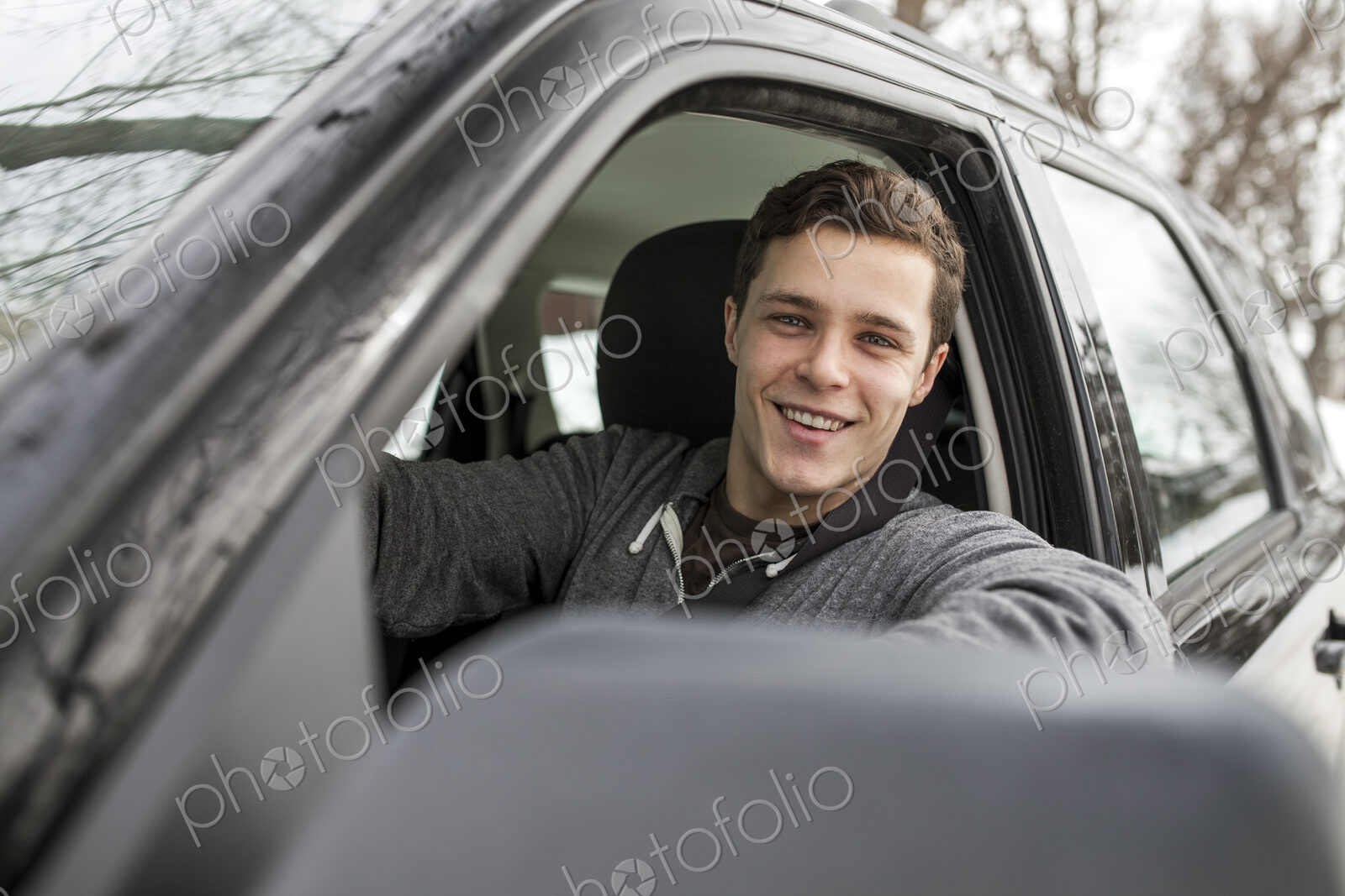Caucasian man smiling in car window