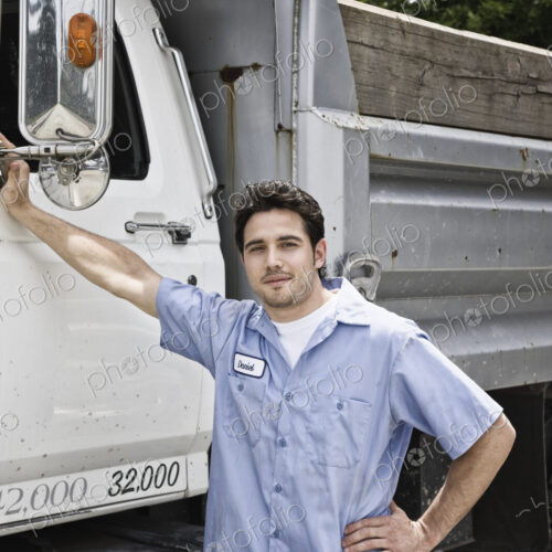 Caucasian man truck driver next to company truck.