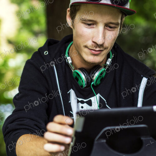 Caucasian man using digital tablet outdoors Caucasian man using digital tablet outdoors