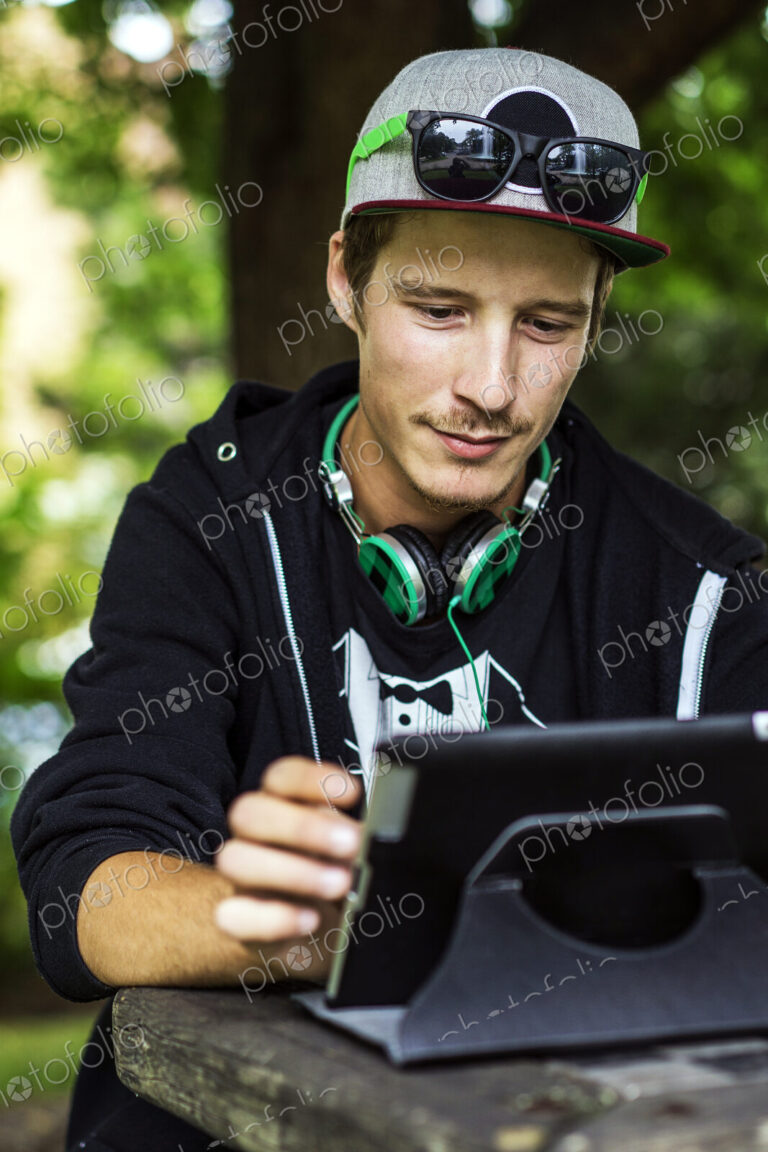 Caucasian man using digital tablet outdoors