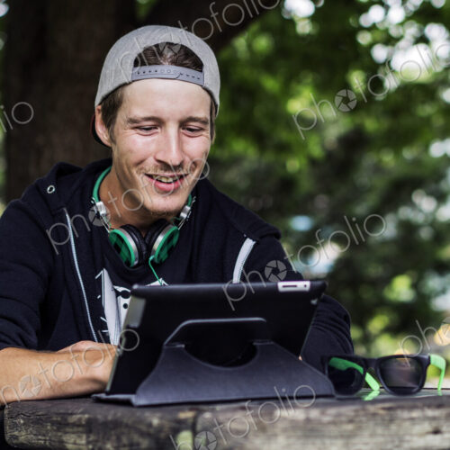 Caucasian man using digital tablet outdoors Caucasian man using digital tablet outdoors