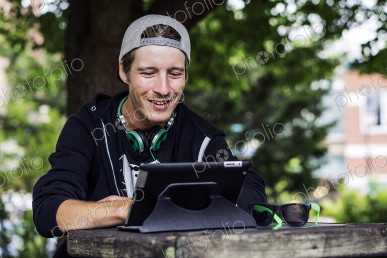 Caucasian man using digital tablet outdoors