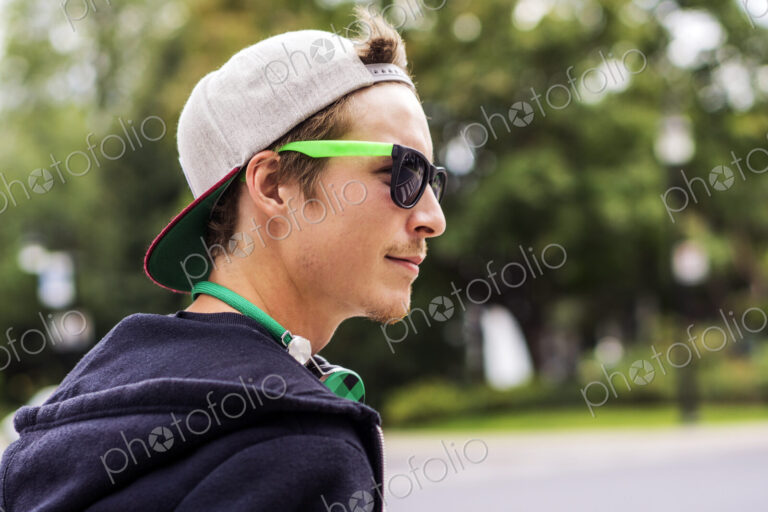 Caucasian man wearing sunglasses and headphones