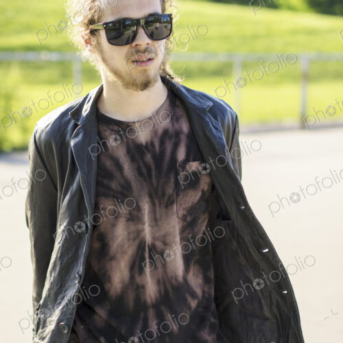 Caucasian man with beard carrying skateboard Caucasian man with beard carrying skateboard