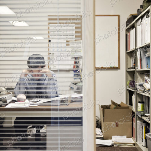 Caucasian man working in an executive office.