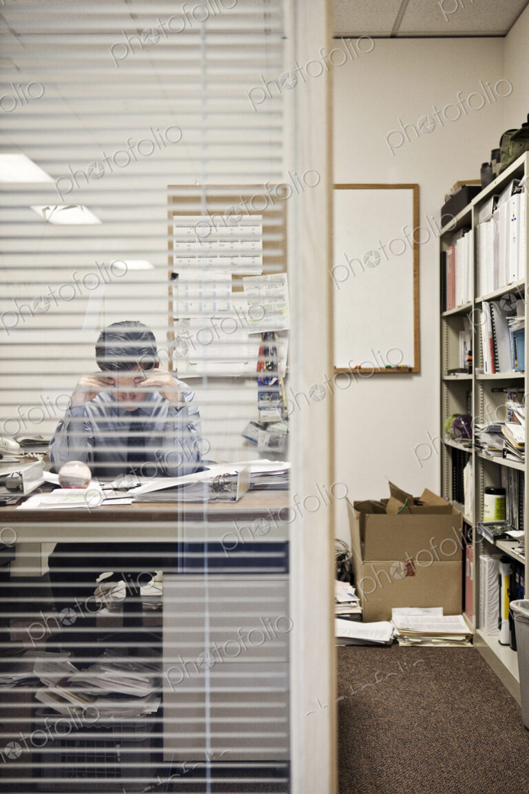Caucasian man working in an executive office.