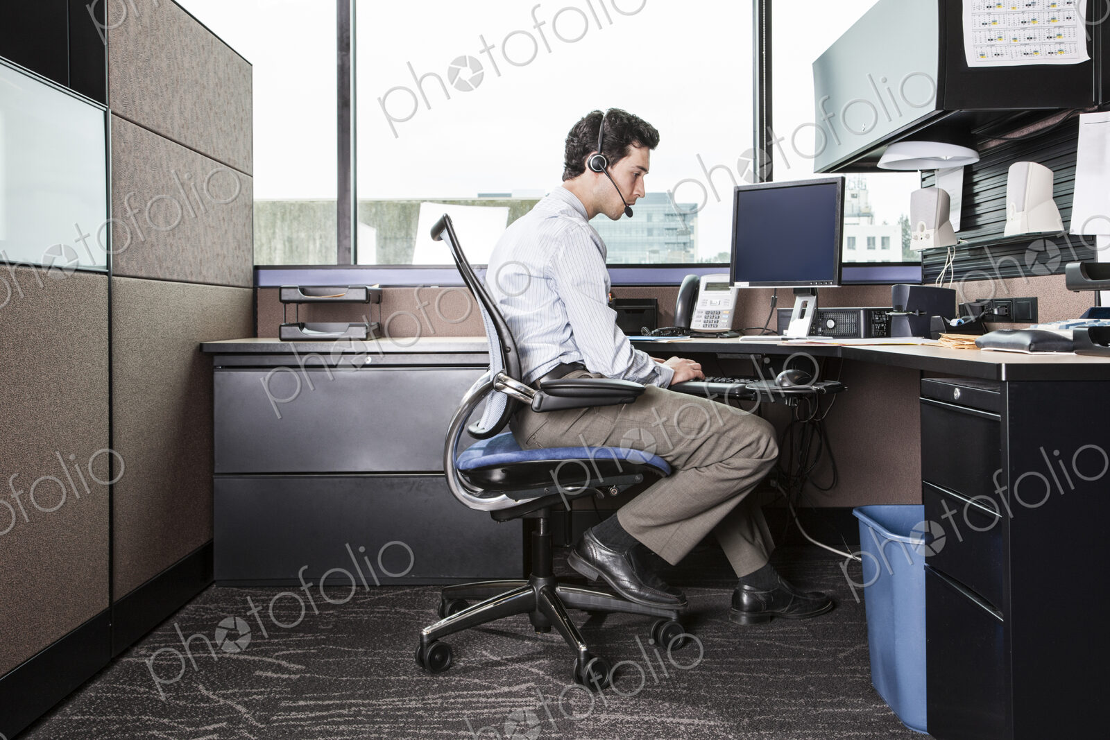 Caucasian man working in an office cubicle.