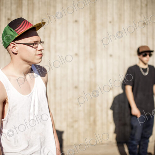 Caucasian men with skateboards near wooden wall Caucasian men with skateboards near wooden wall