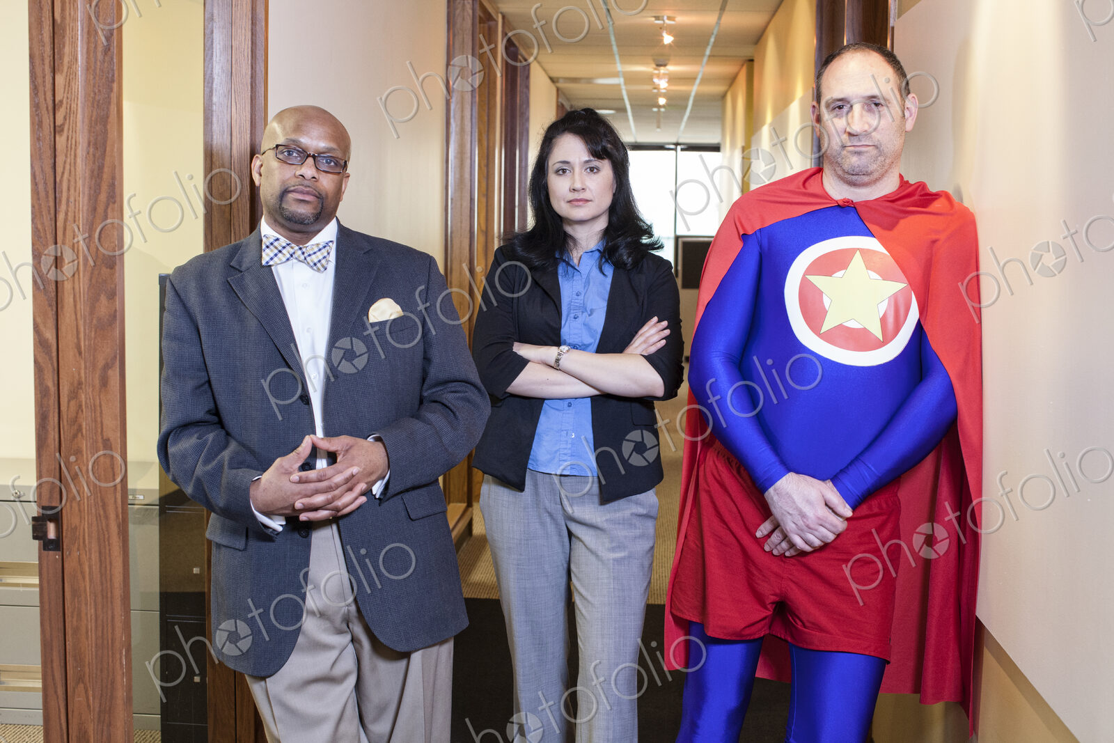 Caucasian middle aged man super hero and his mixed race team staff in their office