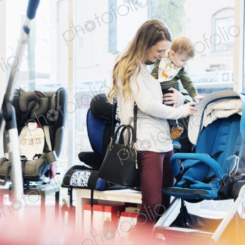 Caucasian mother and baby son shopping in stroller store