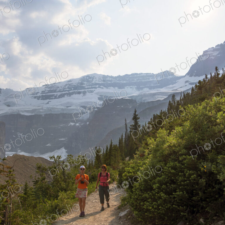 Caucasian mother and daughter hiking on Six Glaciers Trail, Banff, Alberta, Canada