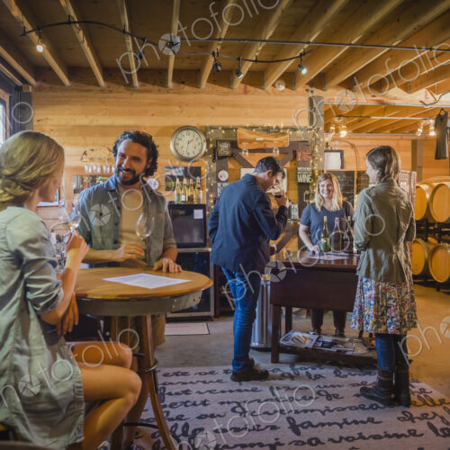 Caucasian people drinking wine in winery