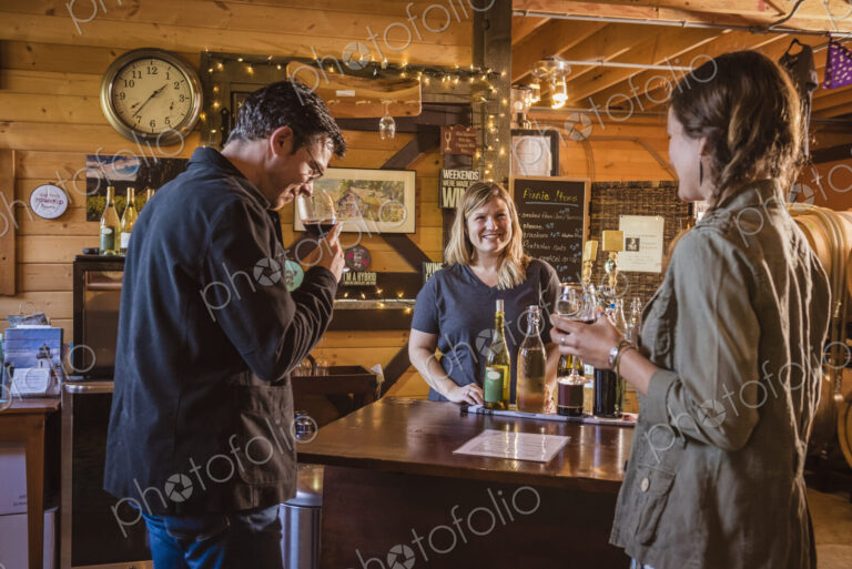 Caucasian people drinking wine in winery